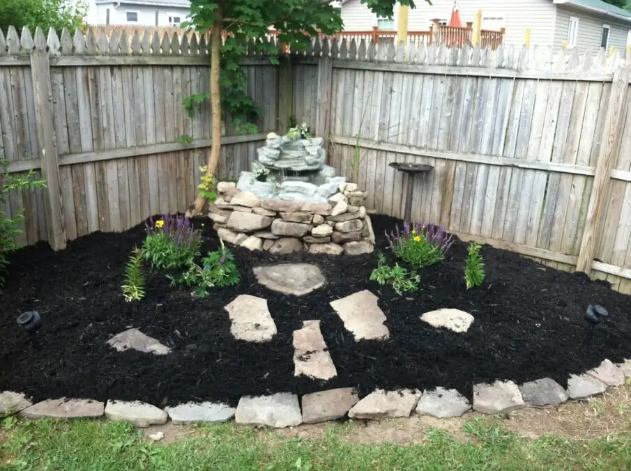 wild garden corner with mulch
