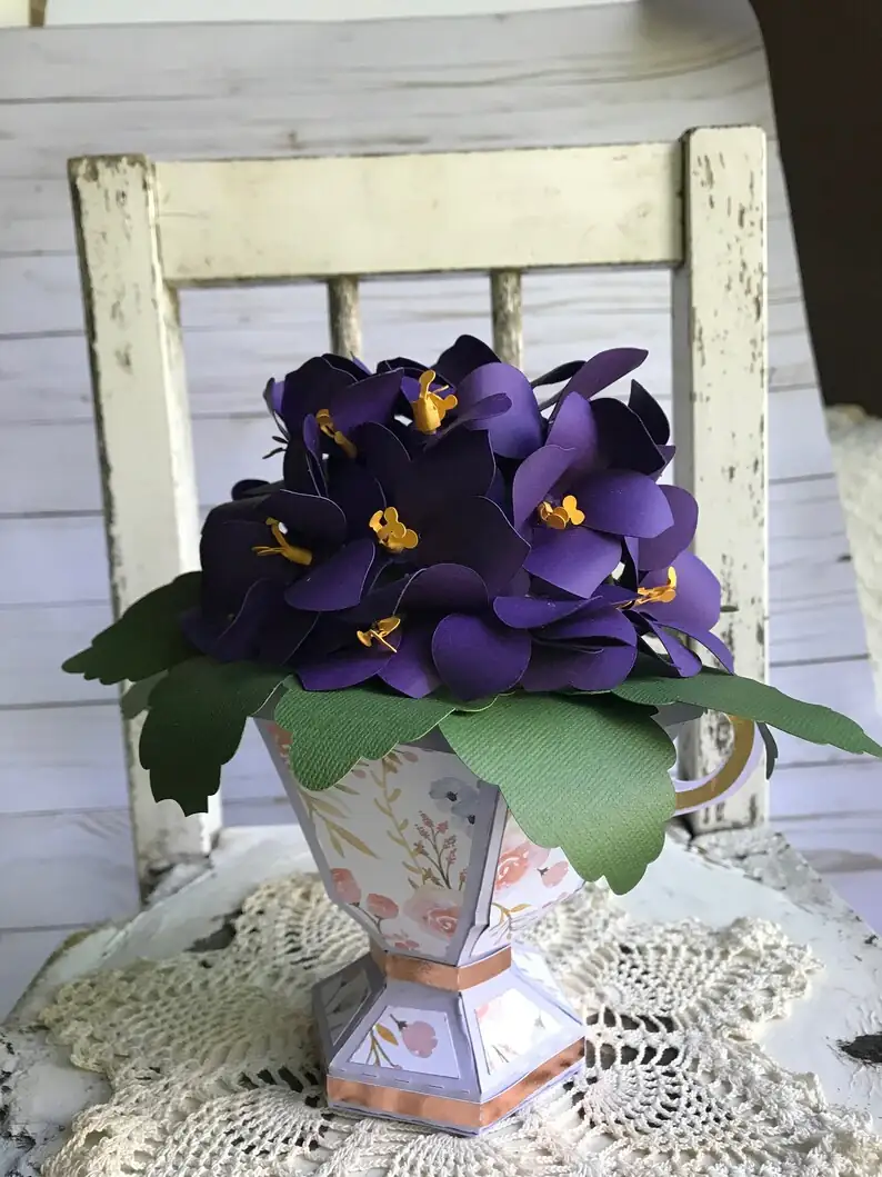 African violets in teacups centerpiece