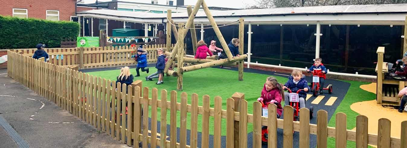child playing in fenced garden area