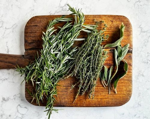 sage rosemary thyme on cutting board